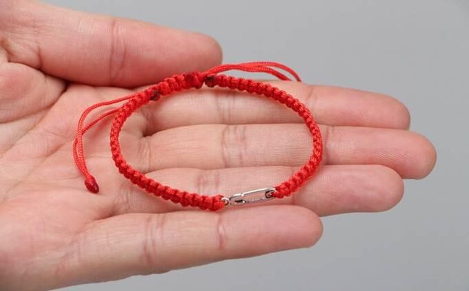 Red thread that protects from harm (on the left wrist) and attracts happiness (on the right wrist)
